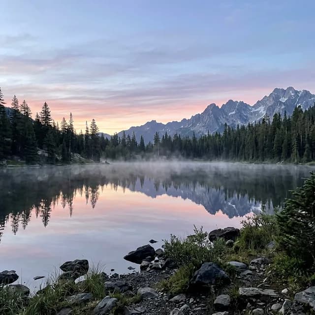 Misty alpine lake at sunrise
